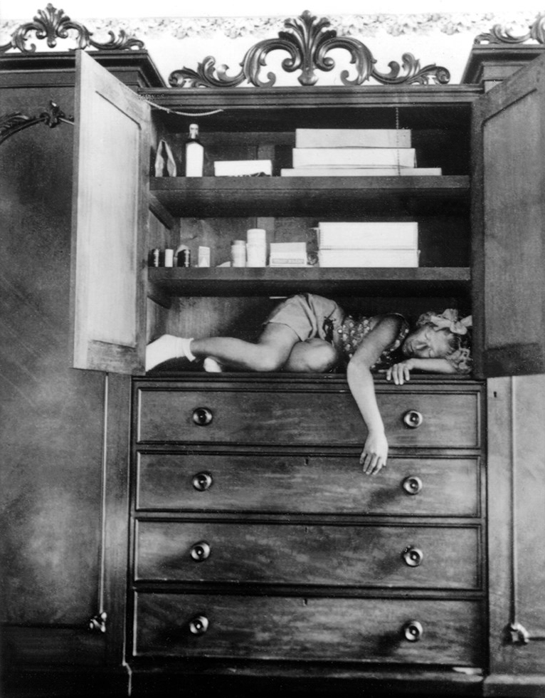 Claude Cahun -- Self-portrait (in cupboard) c. 1932.jpg