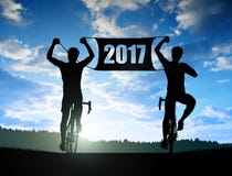 forward-to-new-year-two-cyclists-bicycle-sunset-81169708.jpg